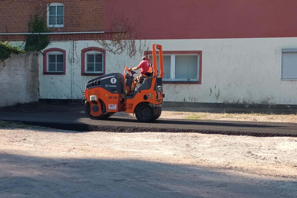 Employees of a specialist company lay asphalt