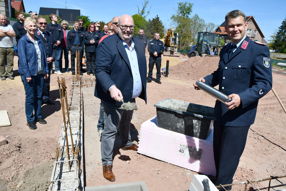Mike Steffens and Andy Opitz prepare to sink the time capsule